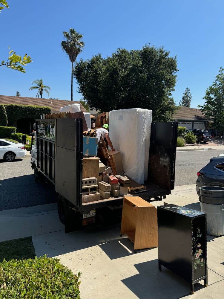 Junk removal crew clearing a large garage in Chatsworth